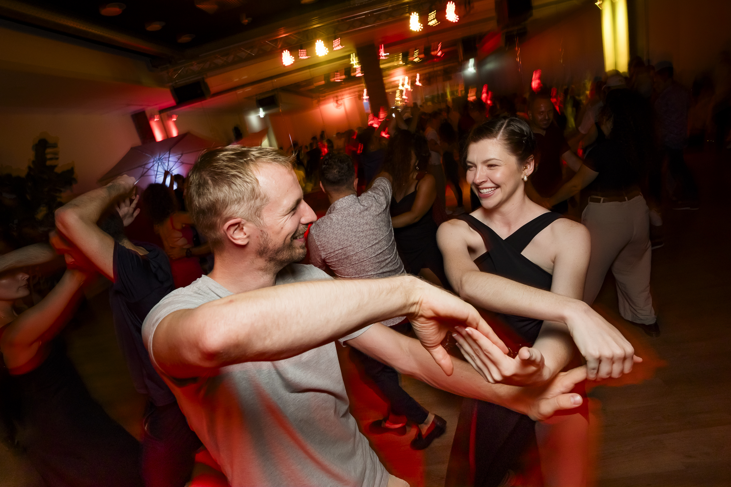 Close-up of vibrant social dancing at night.